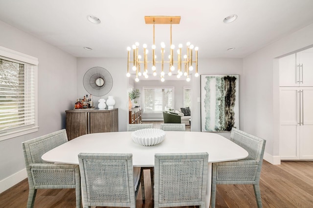 dining space featuring an inviting chandelier and light wood-type flooring