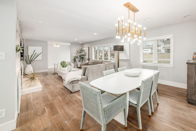 dining area featuring a chandelier and light hardwood / wood-style floors