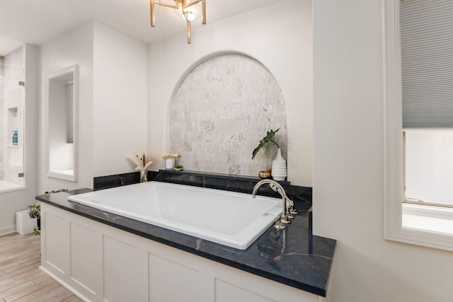 bathroom with hardwood / wood-style flooring and a healthy amount of sunlight