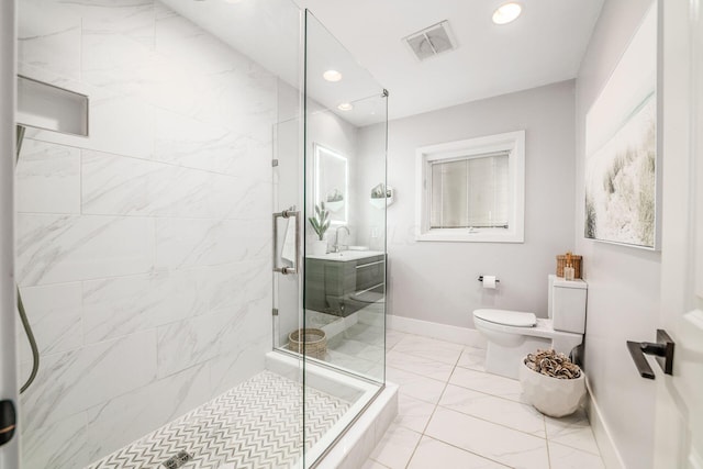 bathroom featuring sink, a shower with shower door, and toilet