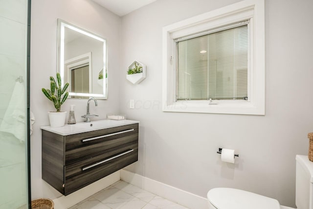 bathroom featuring vanity and toilet