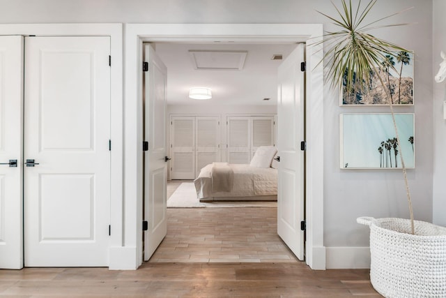 corridor with light hardwood / wood-style flooring