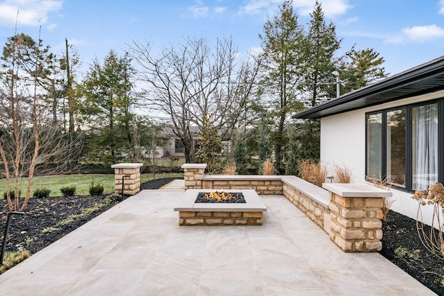 view of patio / terrace featuring an outdoor fire pit