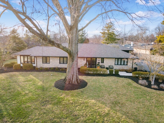 ranch-style home featuring a front yard