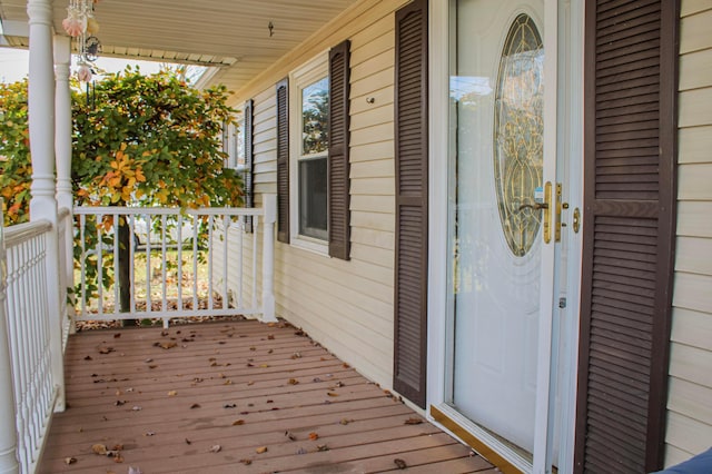 view of exterior entry featuring covered porch