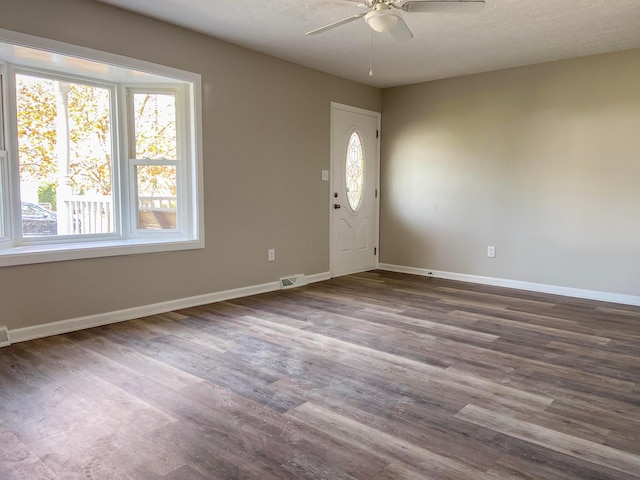 foyer with a textured ceiling, ceiling fan, and dark hardwood / wood-style floors