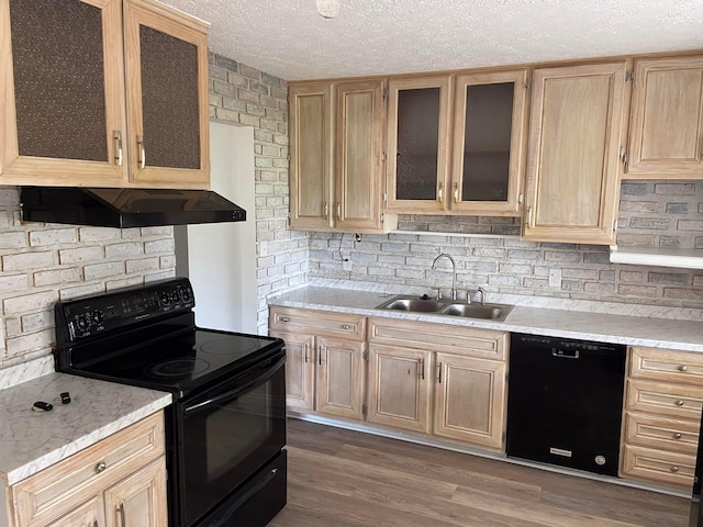 kitchen featuring dark wood-type flooring, exhaust hood, black appliances, sink, and a textured ceiling