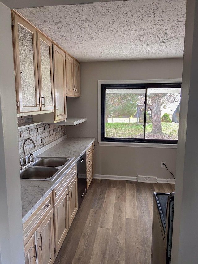 kitchen with stainless steel range with electric cooktop, sink, light hardwood / wood-style flooring, a textured ceiling, and tasteful backsplash