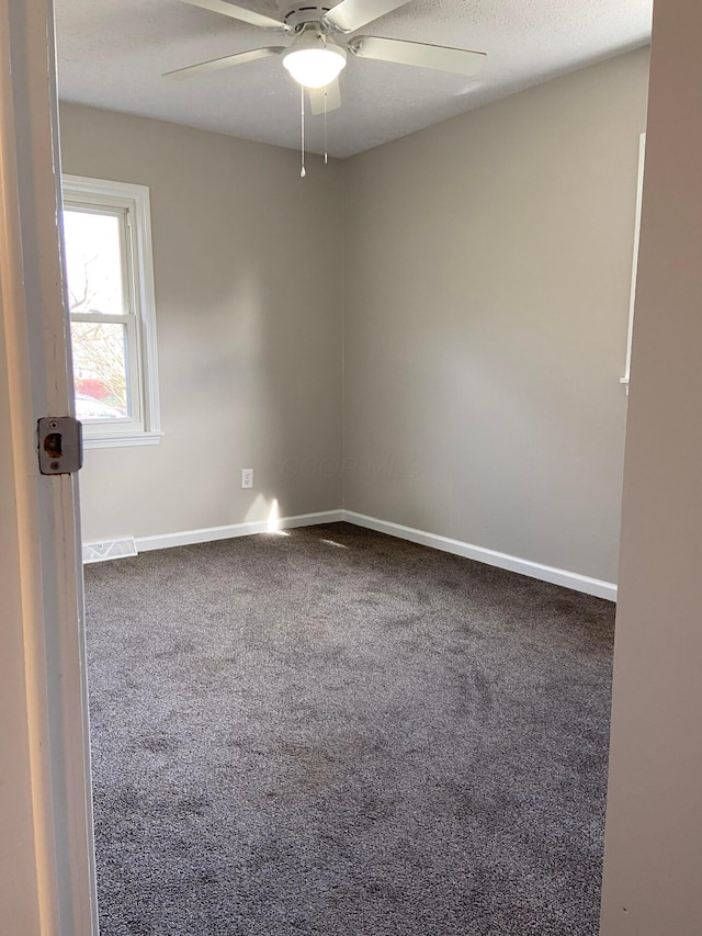 spare room with carpet and ceiling fan