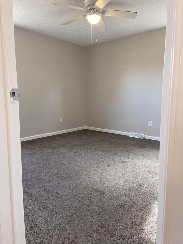 empty room featuring carpet, a textured ceiling, and ceiling fan