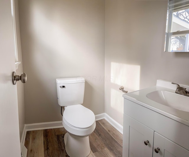 bathroom featuring hardwood / wood-style floors, vanity, and toilet