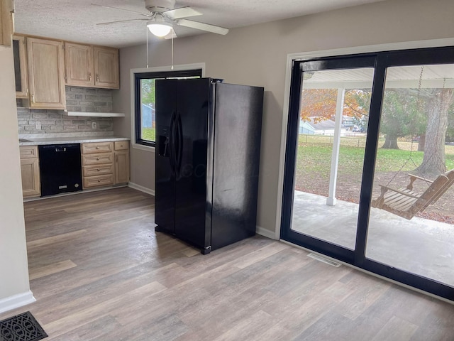 kitchen with ceiling fan, tasteful backsplash, light hardwood / wood-style floors, light brown cabinetry, and black appliances