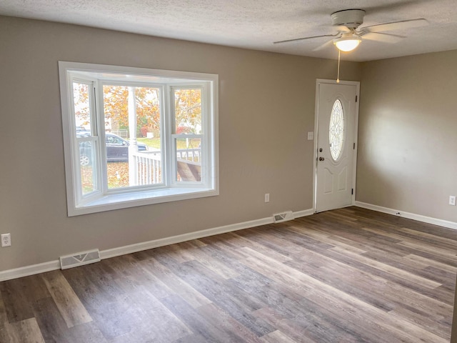 entryway featuring hardwood / wood-style flooring, ceiling fan, and a textured ceiling