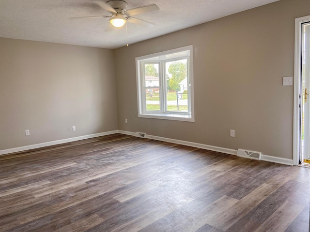 unfurnished room featuring a textured ceiling, dark hardwood / wood-style flooring, and ceiling fan