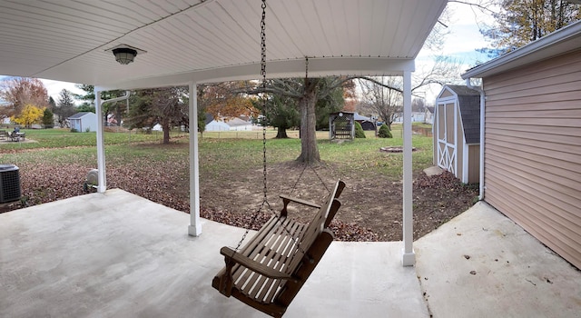 view of patio / terrace featuring a storage unit