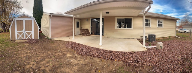 back of property featuring a storage unit and a patio area