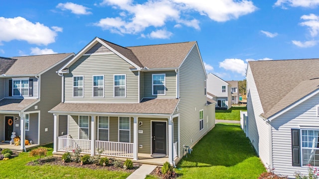 view of front of home with covered porch and a front yard