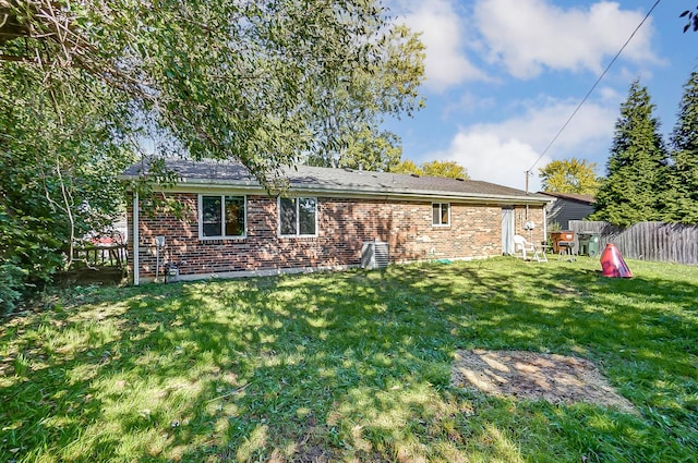 back of house with a lawn