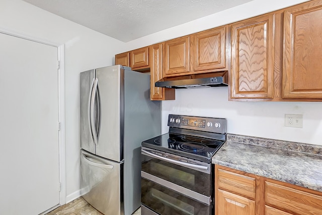 kitchen featuring a textured ceiling, electric range, and stainless steel refrigerator