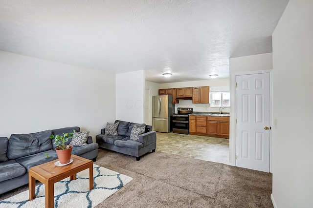 living room with a textured ceiling, light colored carpet, and sink