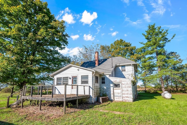 rear view of house with a yard and a deck