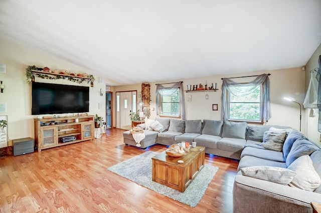 living room with light wood-type flooring and lofted ceiling