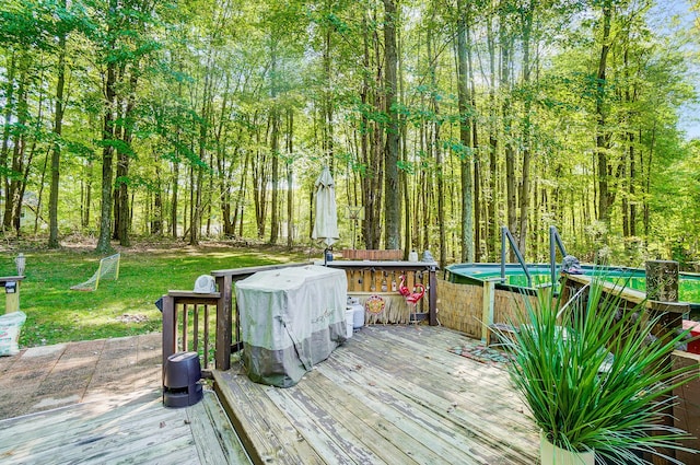 wooden deck featuring a yard