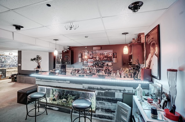 bar with a drop ceiling and hanging light fixtures