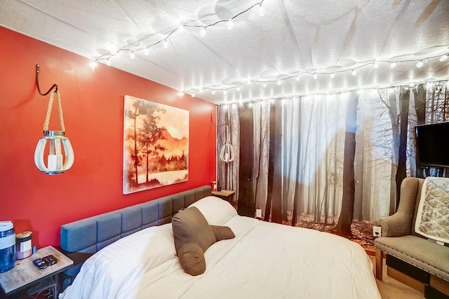 bedroom with track lighting and a textured ceiling