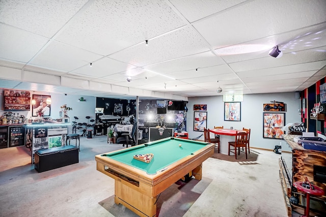 rec room with a paneled ceiling, billiards, and concrete floors