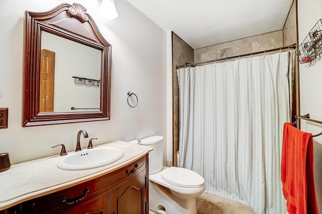 bathroom featuring a textured ceiling, vanity, toilet, and walk in shower