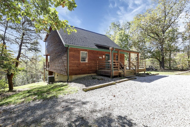 view of front of home with central AC unit and a wooden deck