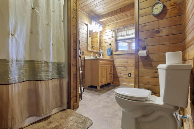 bathroom featuring vanity, wood walls, toilet, and wooden ceiling