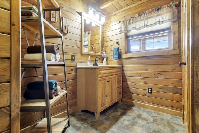 bathroom featuring vanity and wooden walls