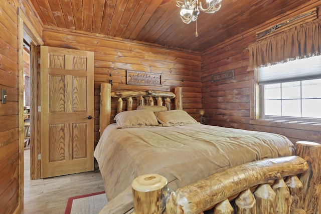 bedroom with log walls, wooden ceiling, and light wood-type flooring