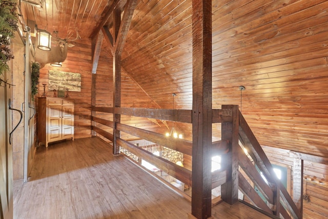 bonus room featuring hardwood / wood-style floors, wooden walls, vaulted ceiling, and wooden ceiling