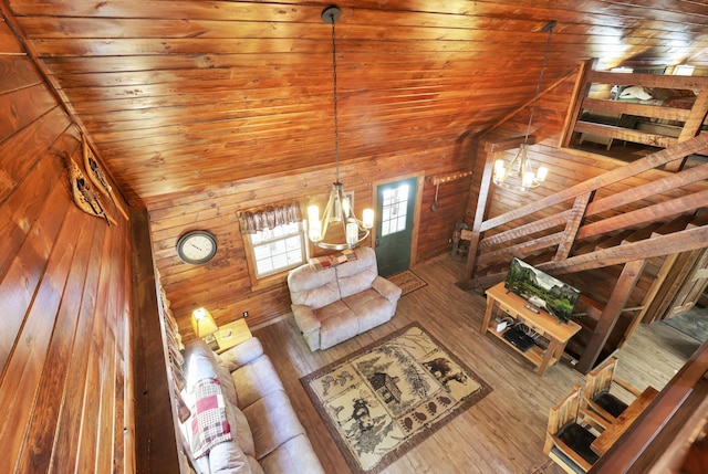 living room with hardwood / wood-style floors, vaulted ceiling, a notable chandelier, and wood ceiling