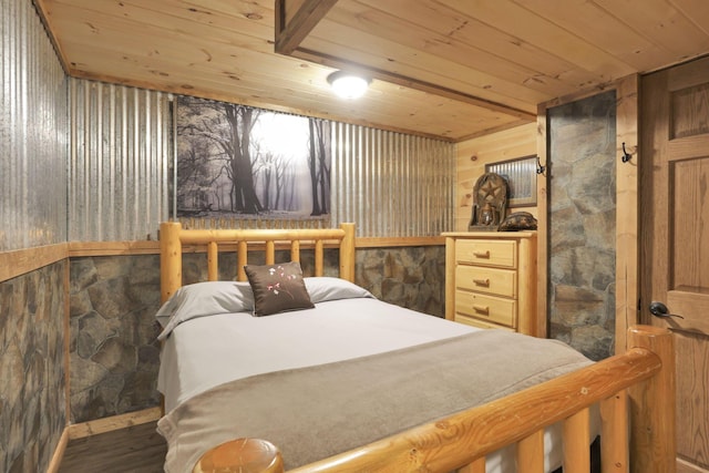 bedroom featuring hardwood / wood-style flooring, wood walls, and wood ceiling