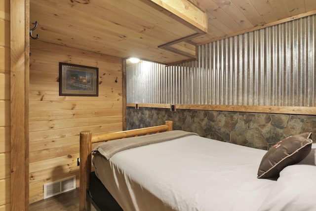 bedroom featuring wood walls, wooden ceiling, and dark hardwood / wood-style floors