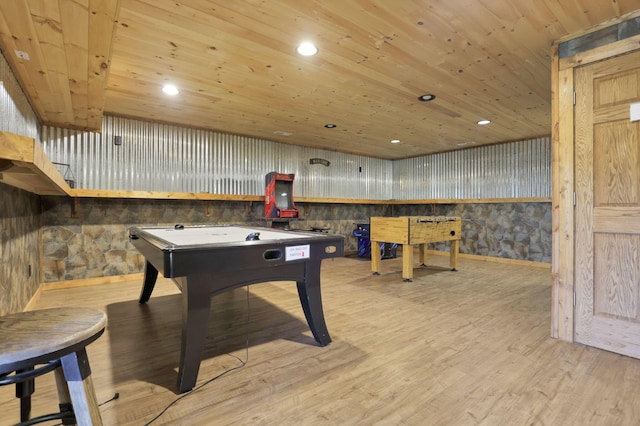 rec room with wood walls, wooden ceiling, and light hardwood / wood-style floors