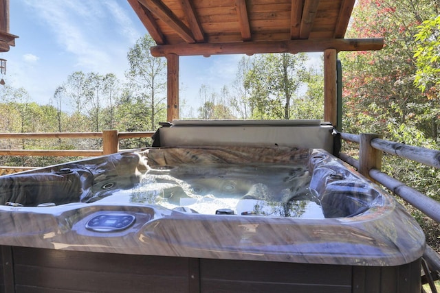 wooden terrace with a hot tub