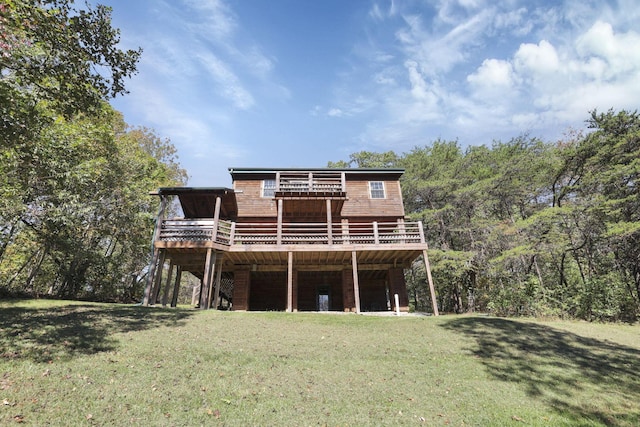 back of property featuring a yard and a deck