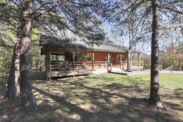 rear view of property with a lawn and a wooden deck