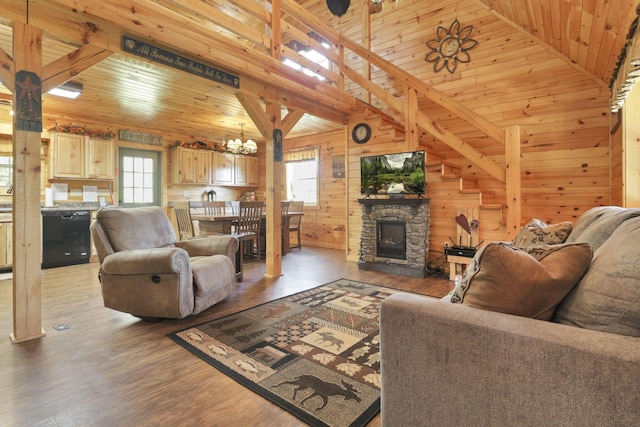 living room with plenty of natural light, wood walls, wood-type flooring, and wooden ceiling