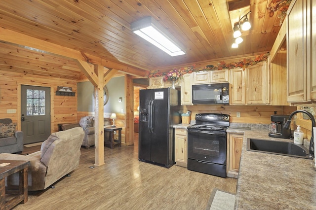 kitchen featuring black appliances, sink, wooden walls, light wood-type flooring, and wood ceiling