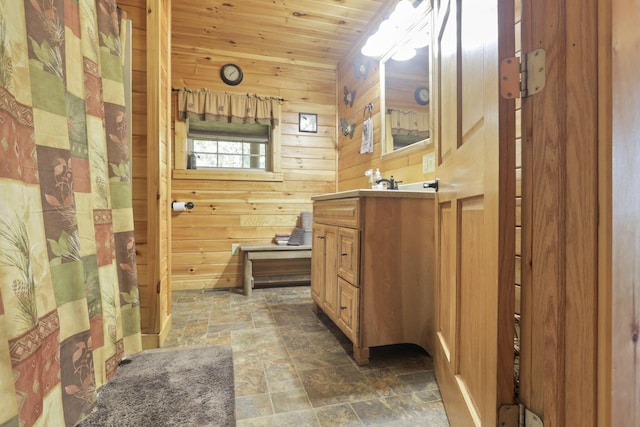 bathroom with wood walls, vanity, and wooden ceiling