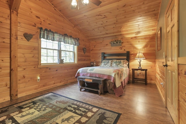 bedroom with wooden walls, wood-type flooring, and vaulted ceiling