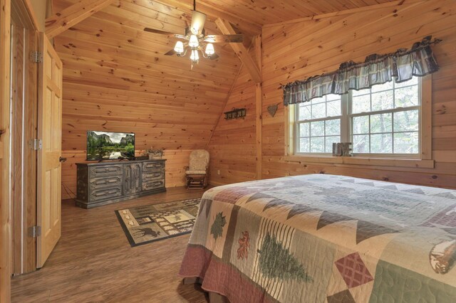 bedroom featuring ceiling fan, wood-type flooring, vaulted ceiling, wooden walls, and wood ceiling