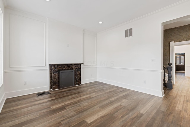 unfurnished living room featuring dark hardwood / wood-style flooring and crown molding