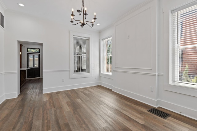 unfurnished dining area featuring a wealth of natural light and dark hardwood / wood-style floors